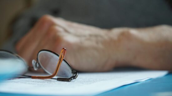 Close up of glasses and male hand on a table