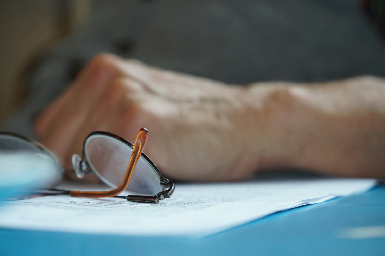Close up of glasses and male hand on a table